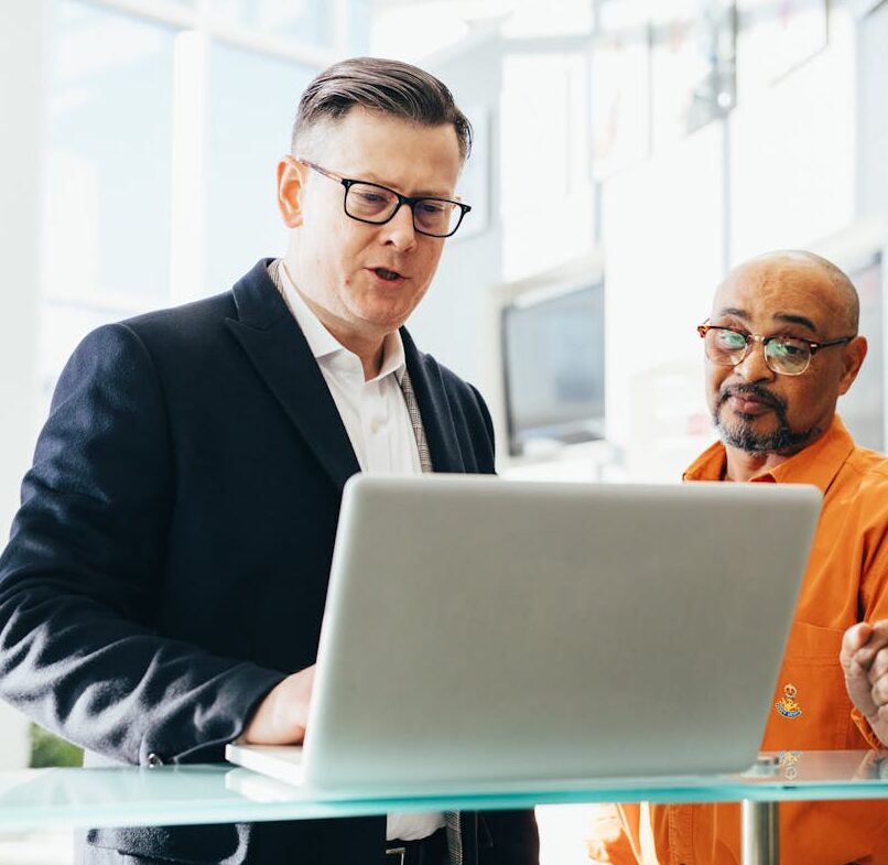 Salesman speaking to customer in person with laptop